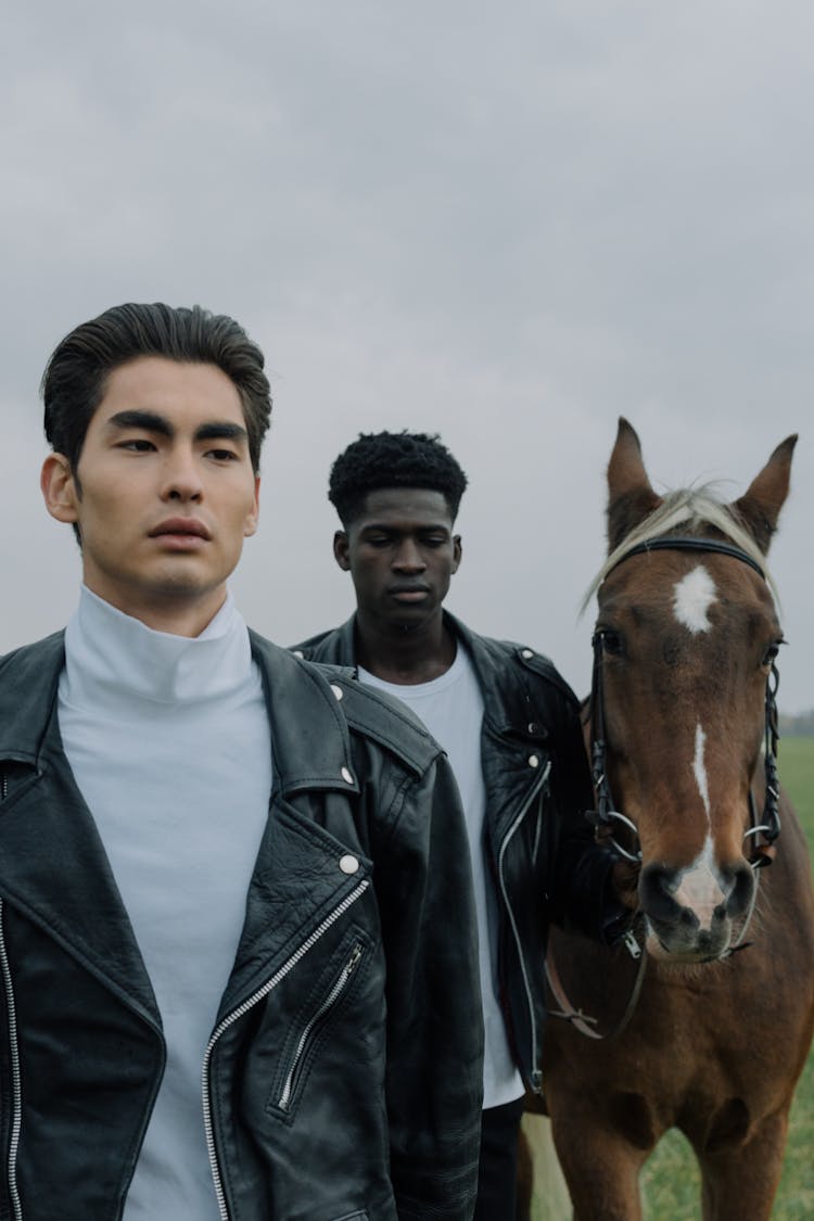 Men Walking With A Brown Horse