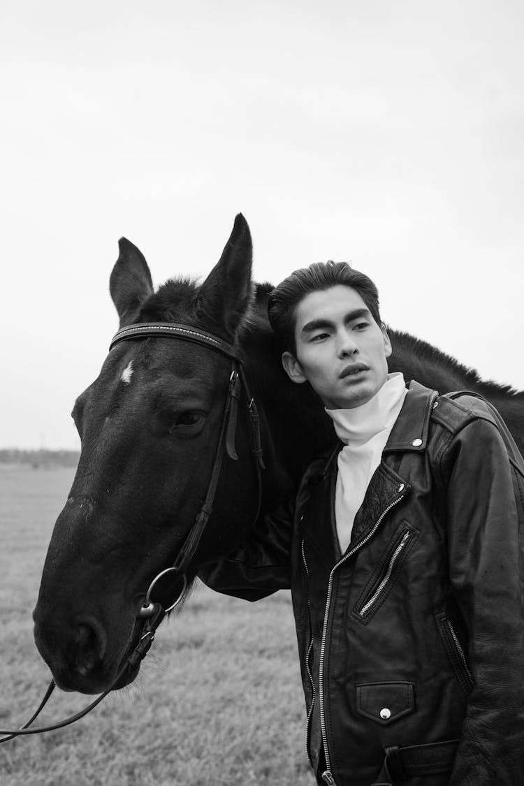 Black And White Photo Of A Man With A Horse