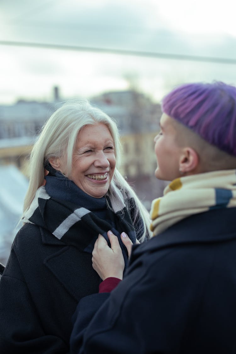 A Smiling Elderly Woman In Winter Clothes