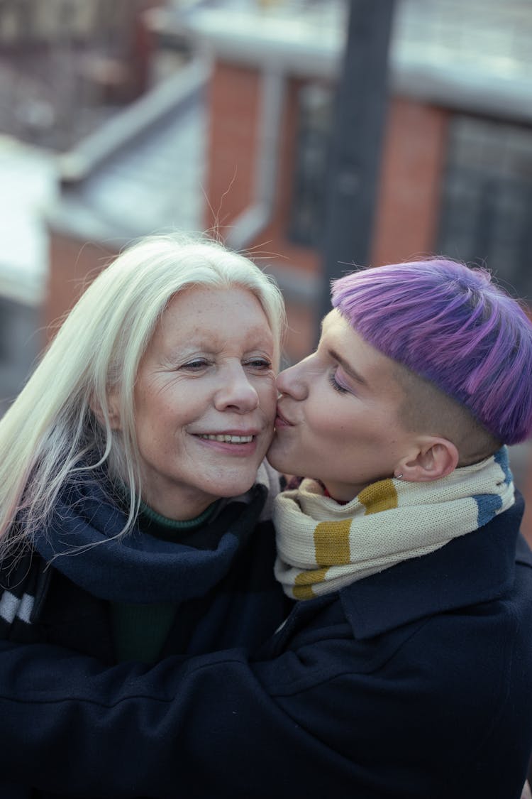 A Woman Kissing An Elderly Woman