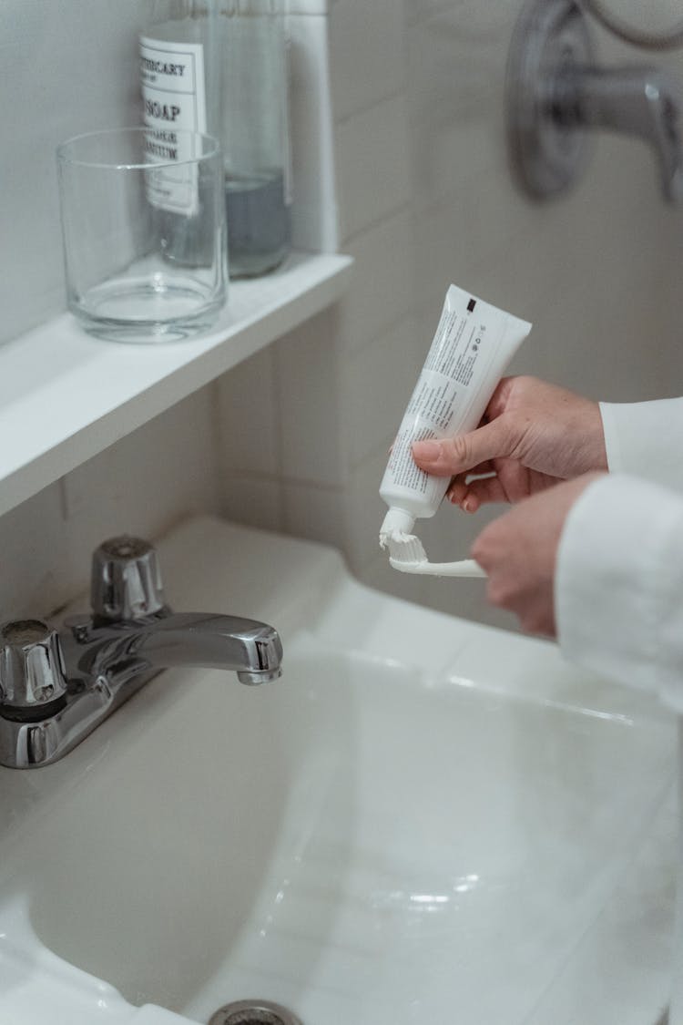 Close-up Of Person Brushing Teeth With Toothpaste