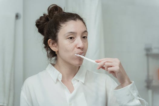 Young woman practicing dental hygiene by brushing her teeth in the morning.
