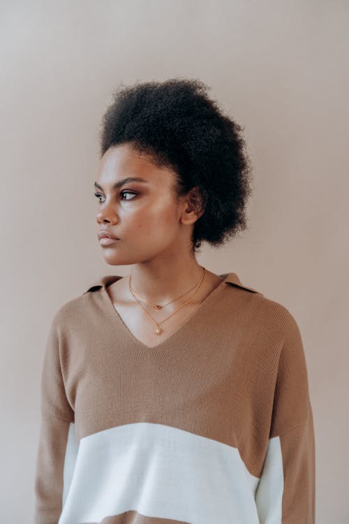 Beautiful Woman in a Brown Long Sleeve Shirt Looking Away