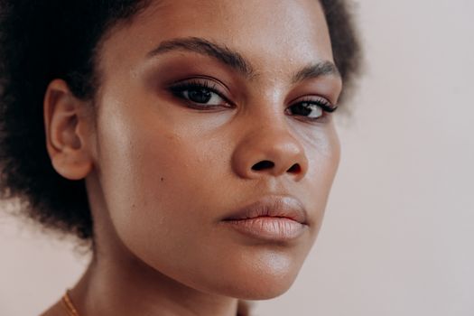 A close-up portrait of a woman exuding confidence with flawless skin and elegant eyeshadow.