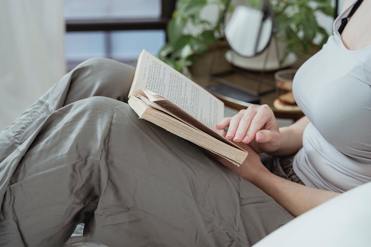 Female Hands Holding Open Book