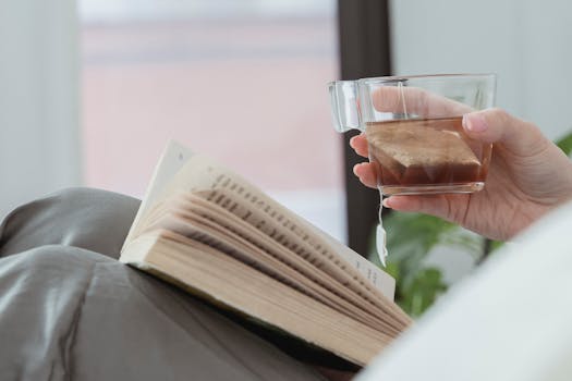 A cozy scene featuring a book and a cup of tea, evoking relaxation.