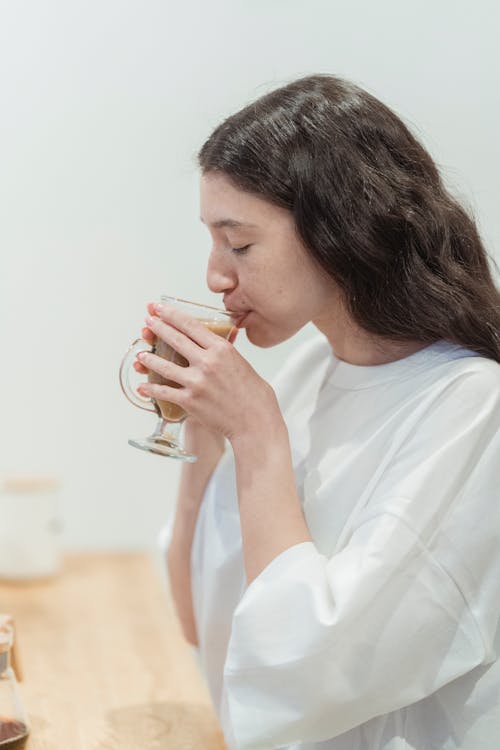Woman in White T-Shirt Drinking Coffee