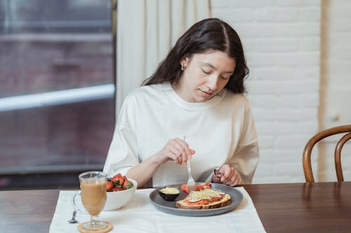 Free Woman Eating a Sandwich Stock Photo