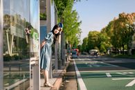 Woman Standing on a Waiting Shed