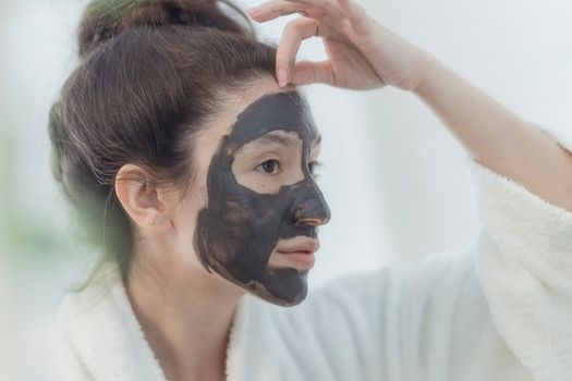 Woman With Black Face Clay Mask
