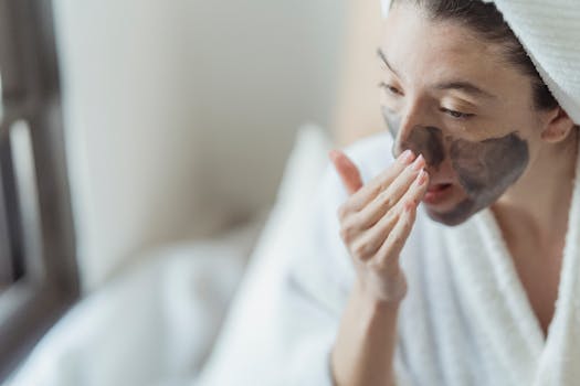 A woman indulges in a skincare routine, applying a facial mask for self-care.
