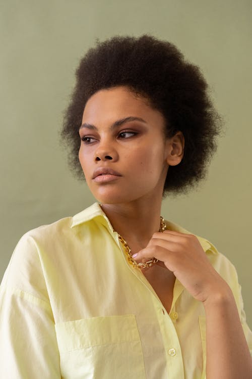 An Afro-Haired Woman in Yellow Long Sleeves