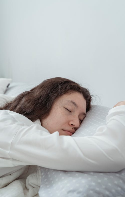 Free A Woman in a White Long Sleeves Sleeping  Stock Photo