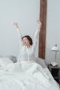 Woman Stretching in Bed after Wakeup