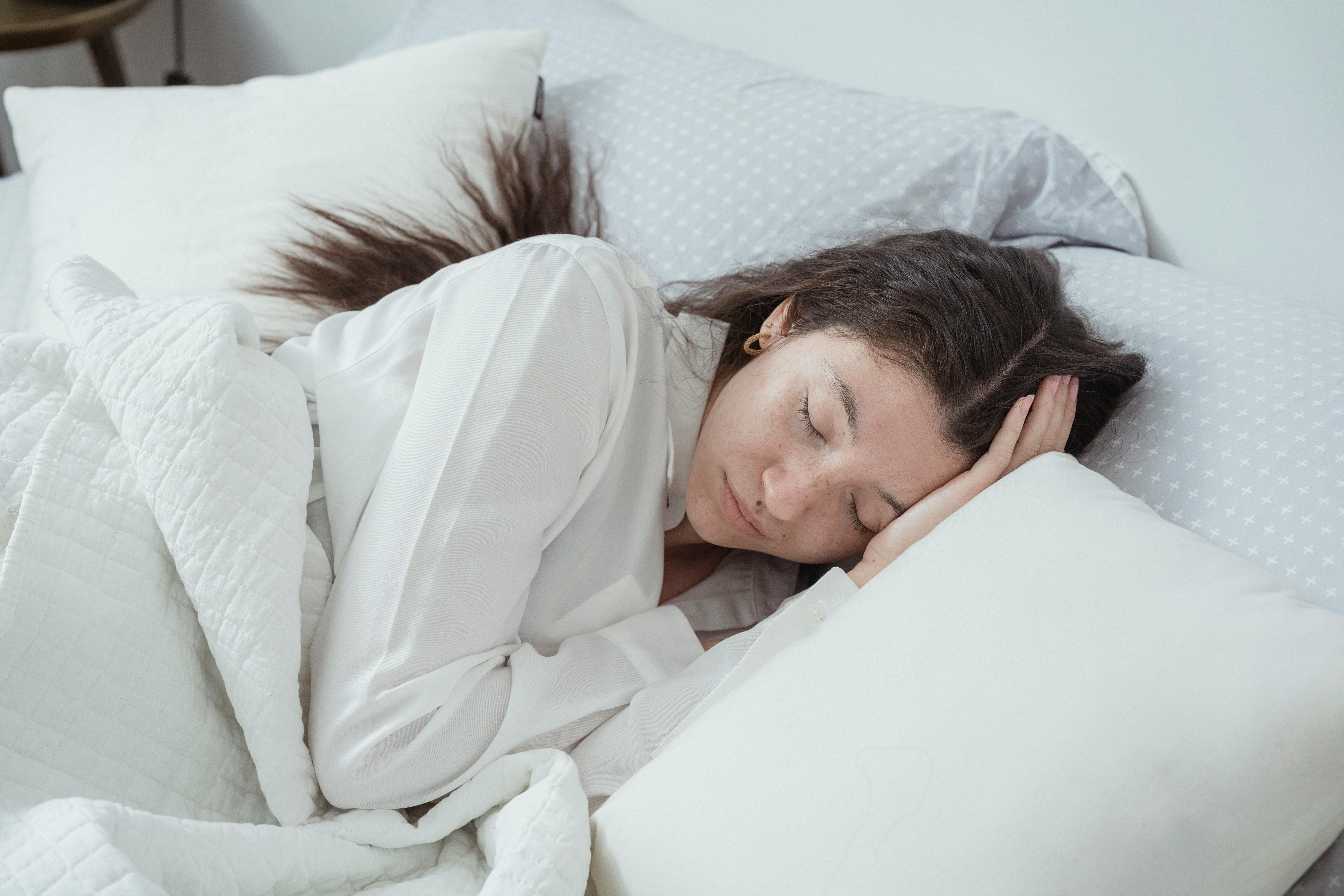 Sleepy woman sleeping in the bed. Stock Photo by ©Voyagerix 112119524