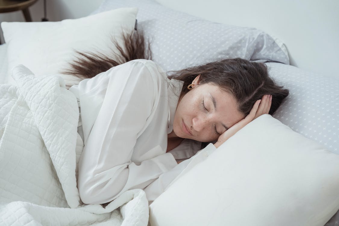 Free A Woman Asleep in a Bed Stock Photo