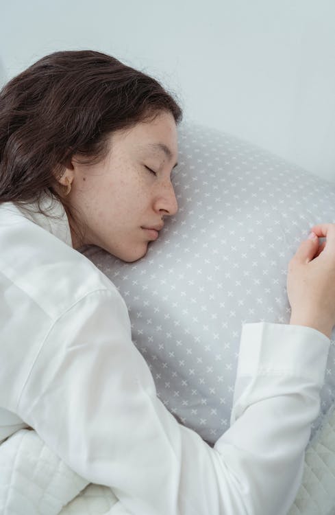 Free A Woman Sleeping on the Bed Stock Photo