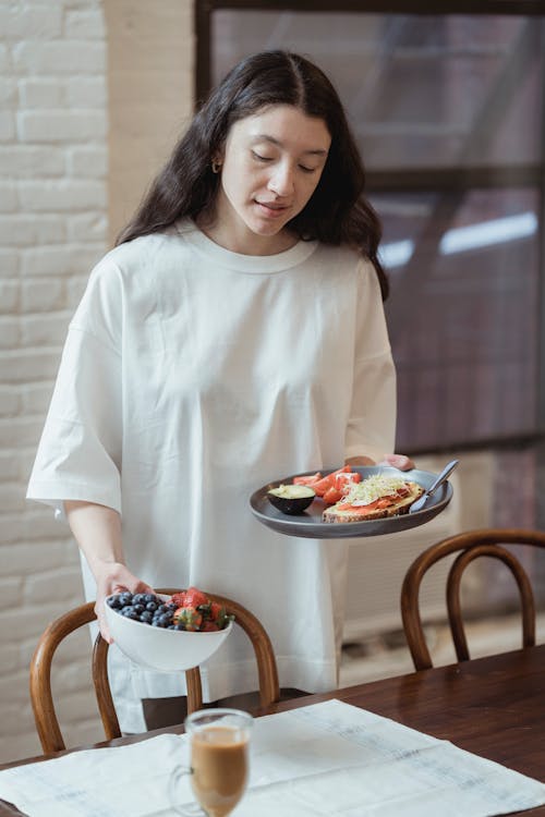 Free A Woman Holding Plate with Food Stock Photo