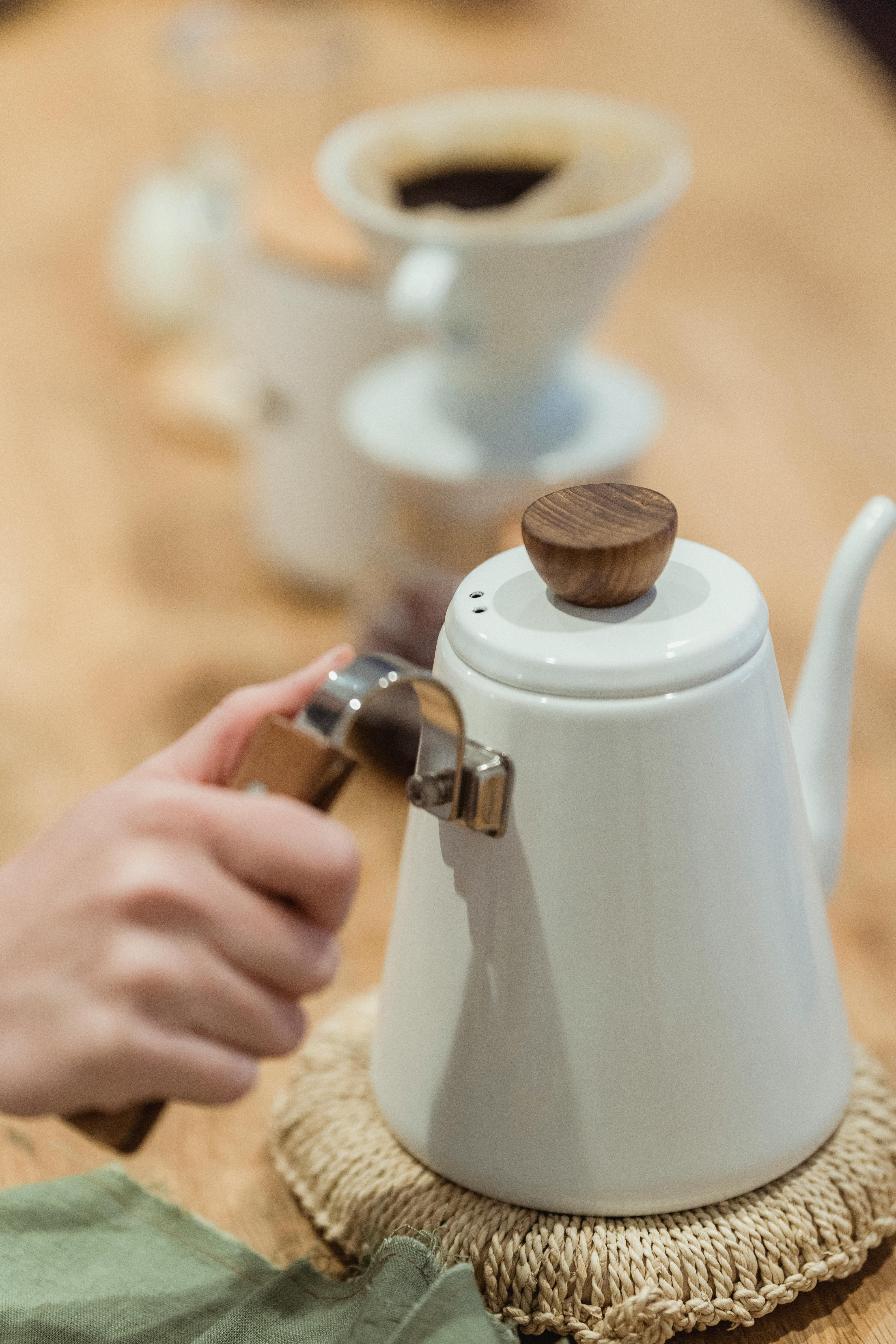 a person holding a kettle