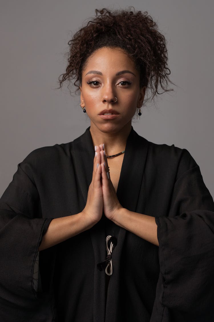 A Woman Wearing A Black Graduation Toga