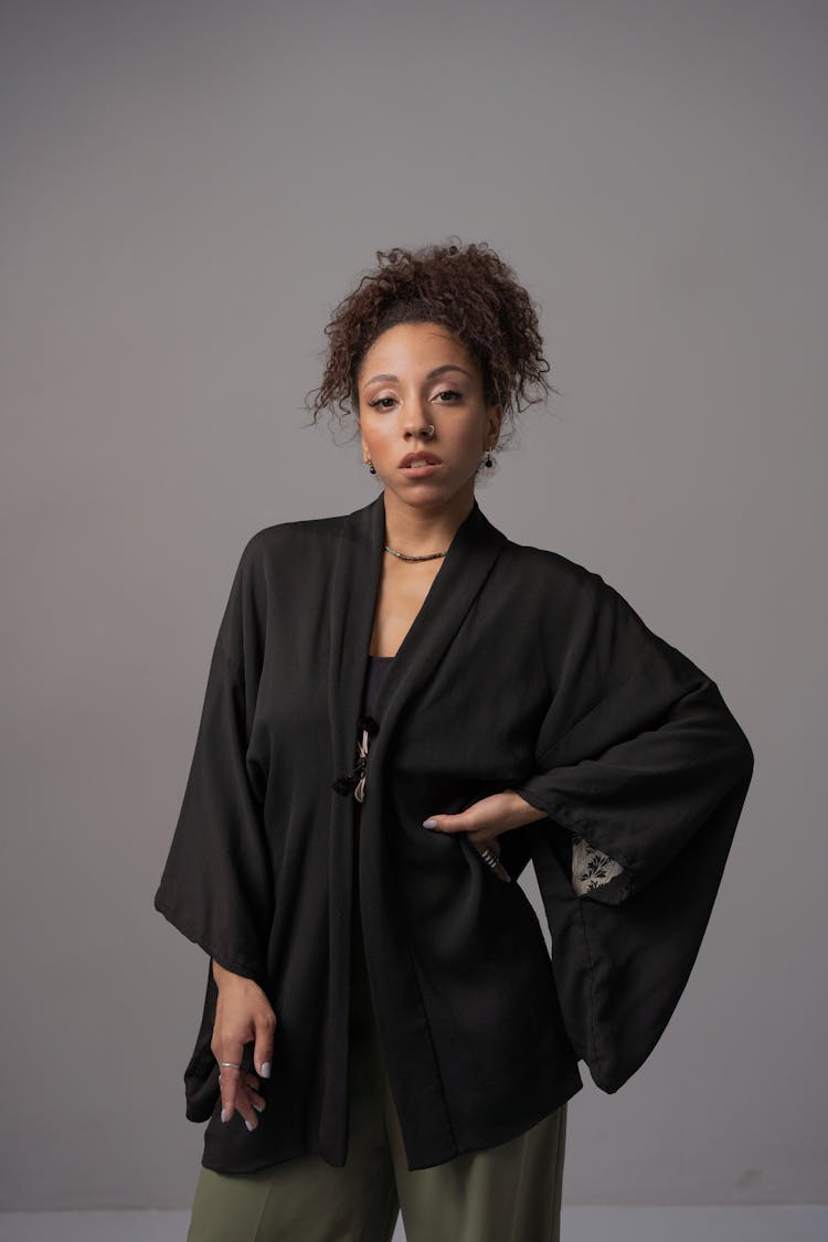 An Afro-Haired Woman In Black Robe Posing