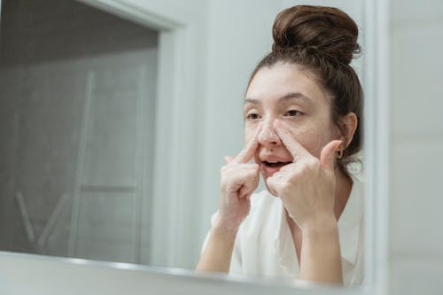 Free Young Woman Washing Her Face in the Bathroom  Stock Photo