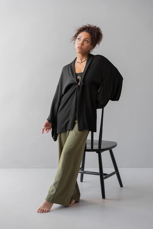 A Woman in Black Long Sleeves and Green Pants