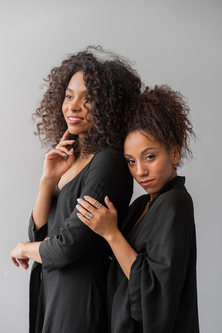 Two Afro-Haired Women In Black Robes 