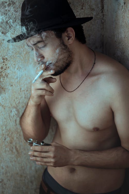 Free Shirtless Man Smoking a Cigarette Stock Photo
