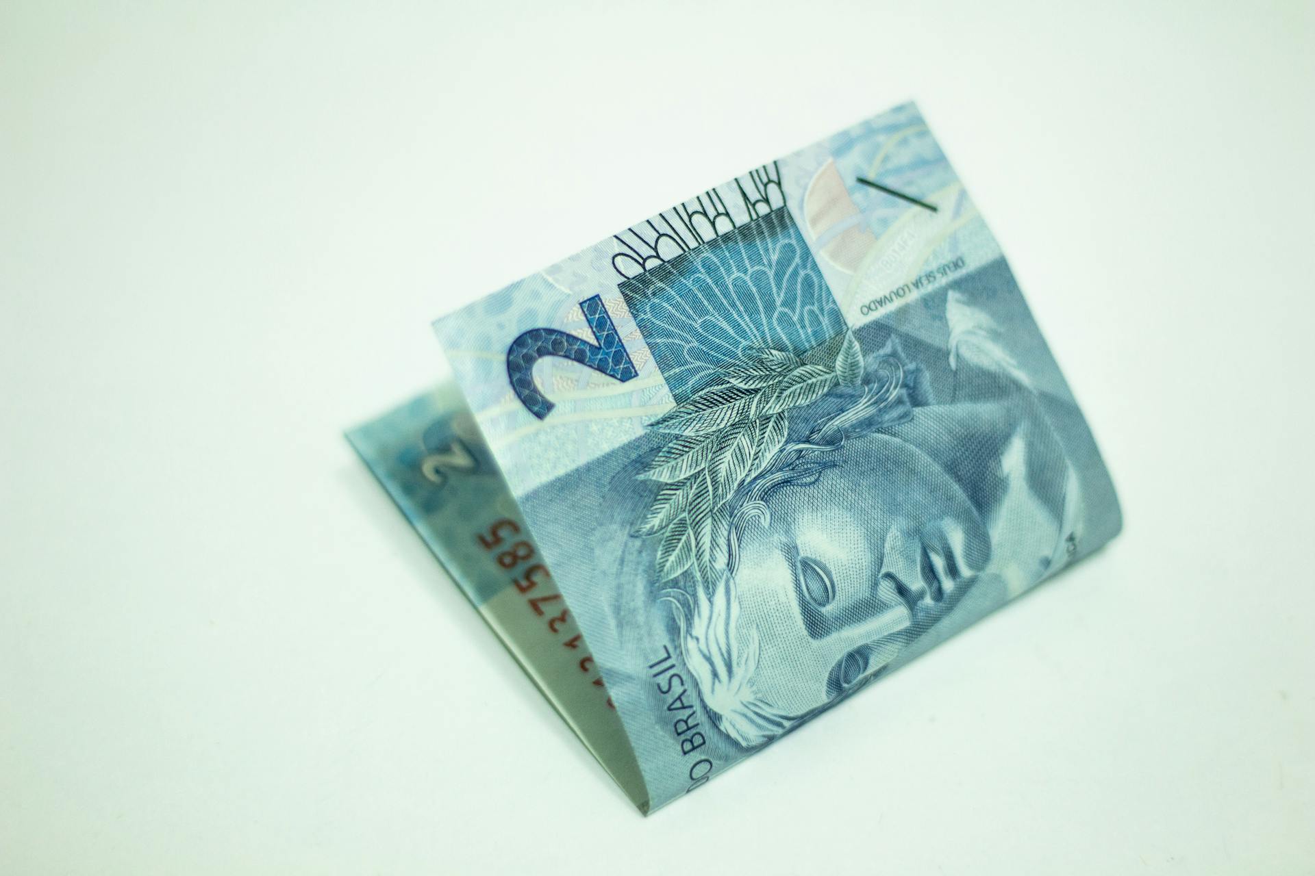 Detailed image of a folded Brazilian 2 reais banknote on a white background.