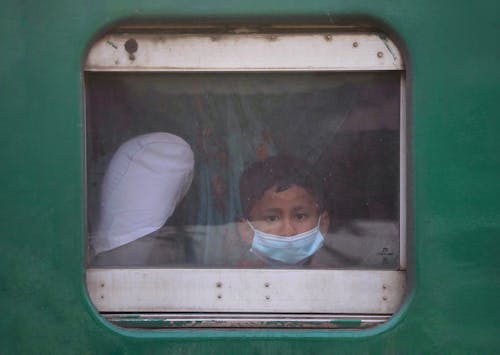 A Boy Looking Through a Window