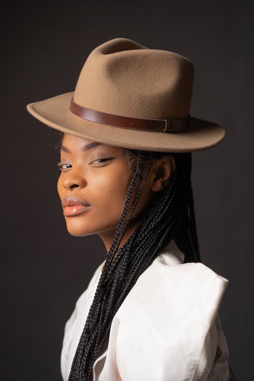 Close-Up Shot of a Pretty Woman in Beige Top and Brown Hat