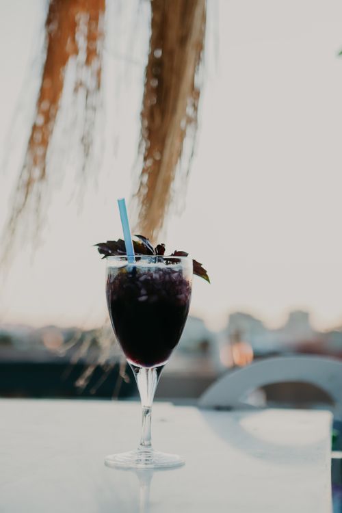 Free A refreshing cocktail with mint and a straw in an elegant glass, perfect for outdoor relaxation. Stock Photo