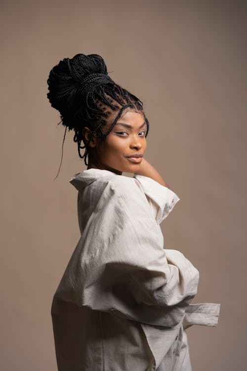 A Pretty Woman in Beige Long Sleeves Posing