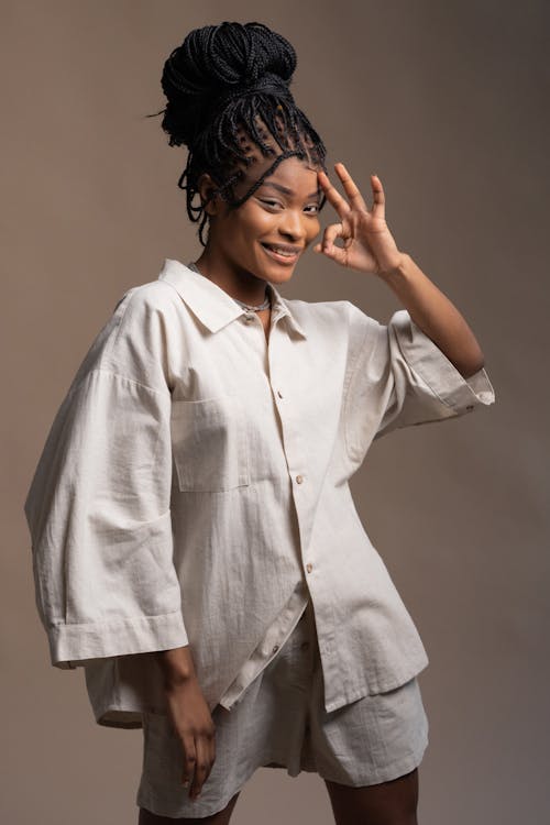 A Pretty Woman in Beige Long Sleeves Posing