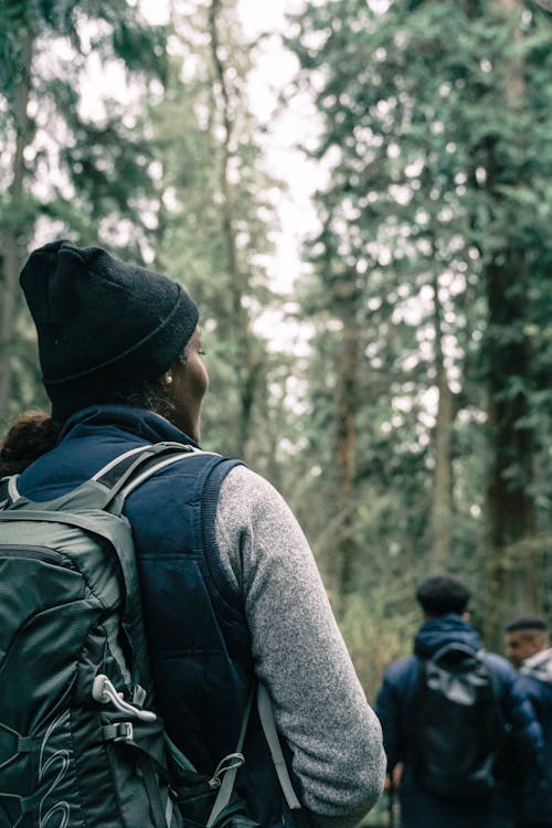 A Woman Smiling while Hiking in a Forest · Free Stock Photo