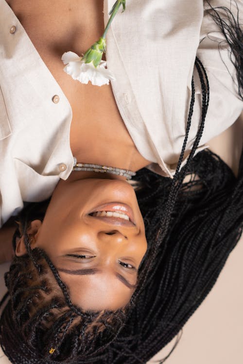 Woman in White Button Up Shirt with White Flower on her Chest