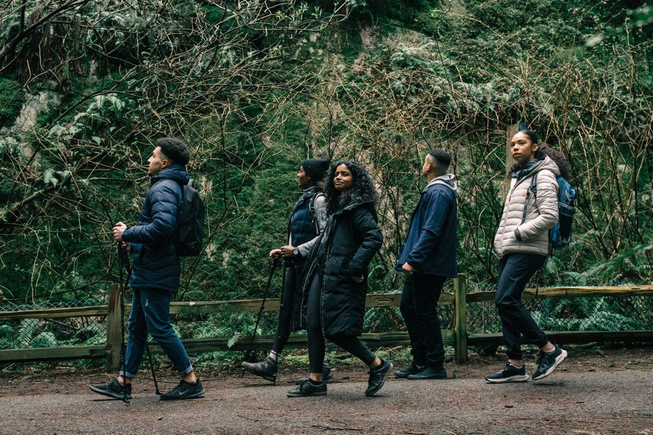 A group of friends enjoying a hike through a scenic forest path, showcasing adventure and camaraderie.