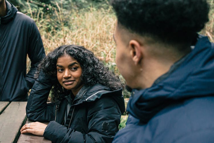 Woman In Black Jacket Listening To The Conversation