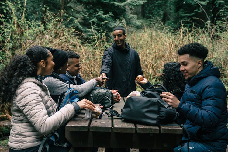 Friends Sharing Snacks To Each Other