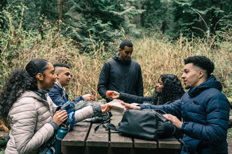 Friends Sharing Snacks To Each Other