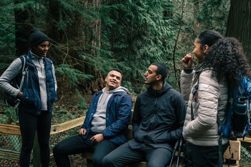 Free Diverse group of friends in hiking gear, enjoying a forest adventure. Stock Photo
