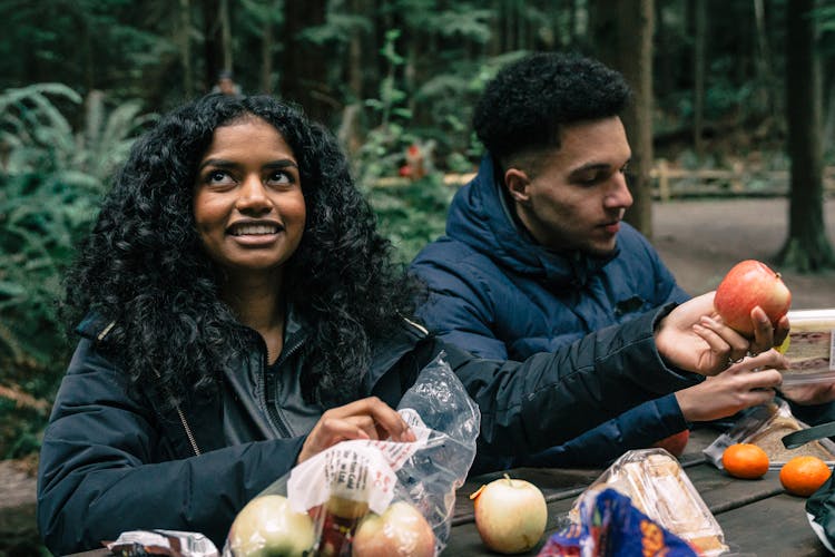 Man And Woman Eating Fruits