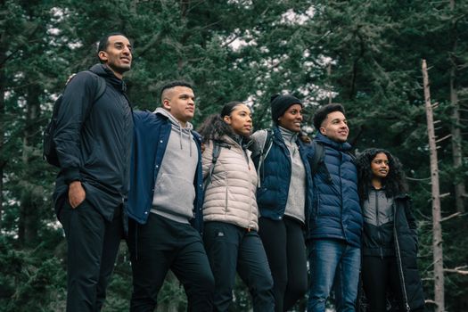 A group of friends enjoying a hiking adventure in a lush forest setting.