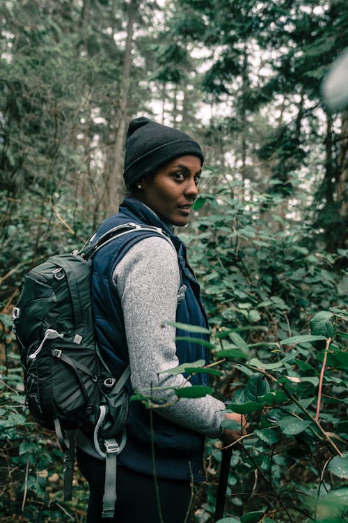 Free Woman Hiking in a Forest Stock Photo