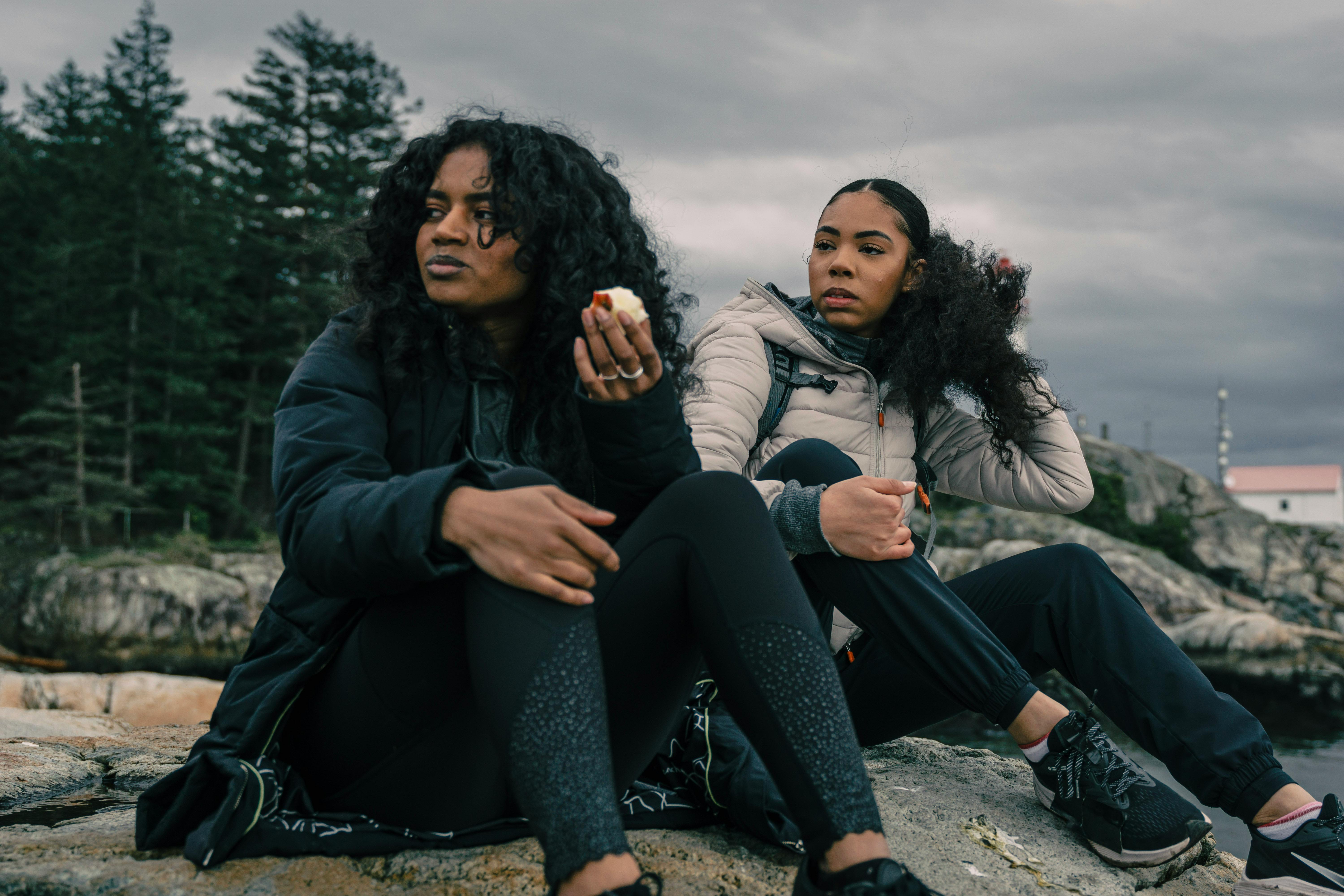 Free Two women enjoy a peaceful moment outdoors, embracing nature's tranquility. Stock Photo
