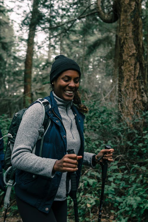 Free Woman Having Fun Hiking in a Forest Stock Photo