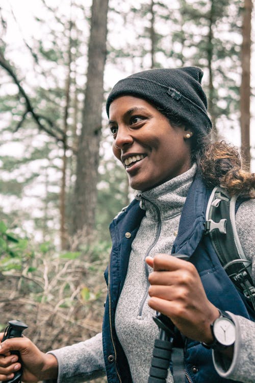 Free A Woman Smiling while Holding Two Trekking Poles Stock Photo