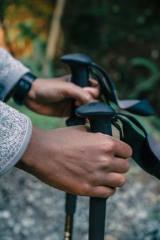 Detailed view of hands grasping hiking poles, perfect for trekking and adventure themes.