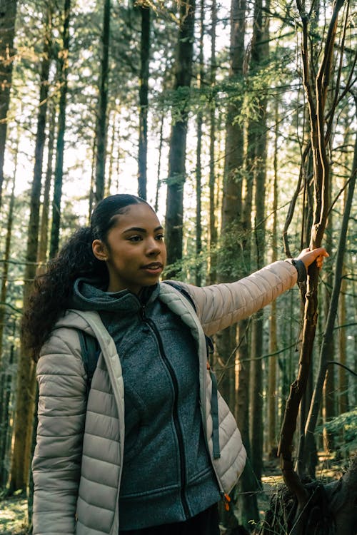 Free Woman Hiking in a Forest Stock Photo